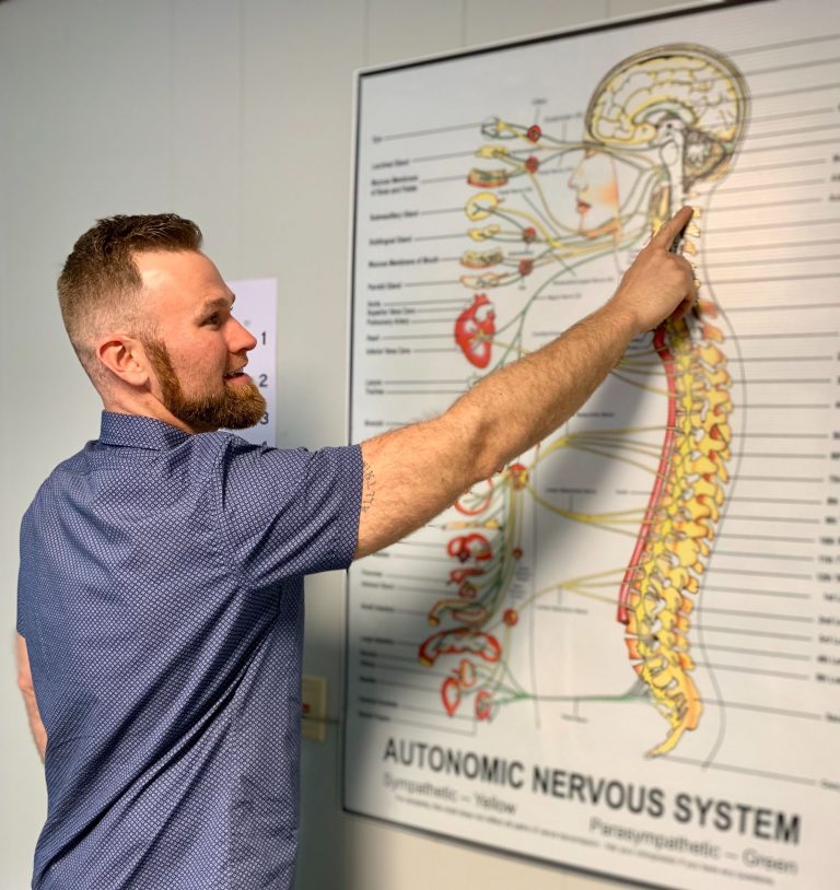 Dr. Joshua Steinke explaining alignment using an image of a skeleton spine